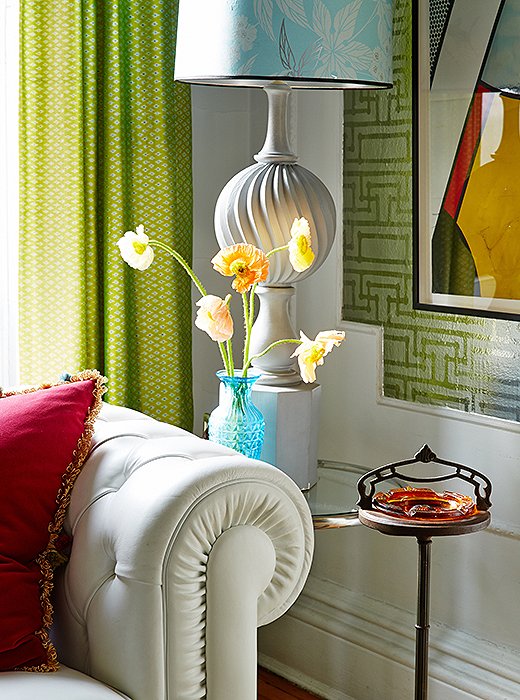 The lamps show Fawn’s high-low approach. “The bases were $50, while the custom shades were pricey.” The metallic Florence Broadhurst wallpaper helps to “bring light into the room.” The Roy Lichtenstein artwork is actually a wallpaper panel that Robert Stern gave Fawn.
