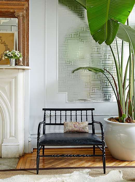 “I love mixing Old World fabric with a contemporary designer,” says Fawn. In her living room, a Marcel Wanders chair holds a petite pillow in fabric by Christopher Hyland.
