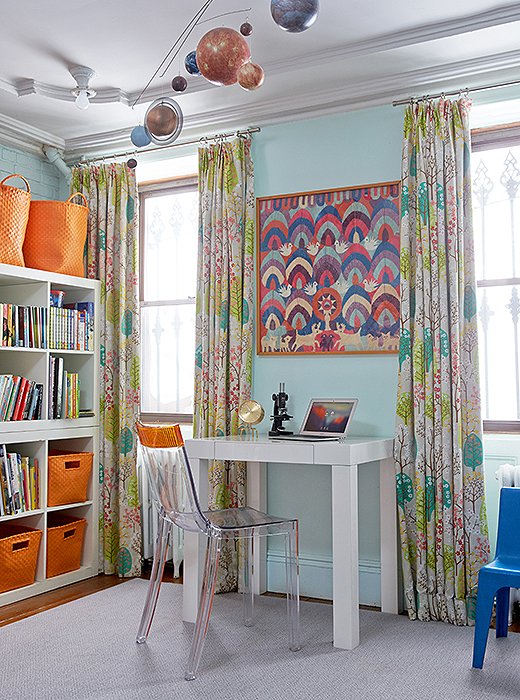 The distinctive mingles with the practical in the boys’ room. A lacquered Parsons desk and an acrylic chair are clean, modern, and most important, durable. A Swedish print on the curtains and framed Mexican textiles (a score from Fawn’s mother-in-law) feel “young and fun but also timeless.”
