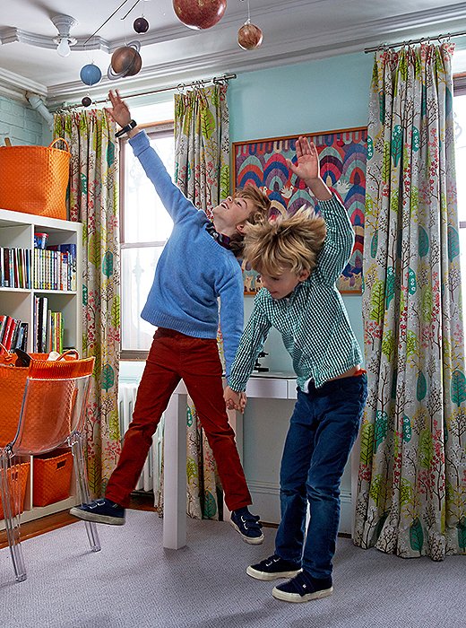 Fawn’s sons, Gaspar and Laszlo, jump for joy in their shared bedroom. “I always tell my clients, Use timeless things that children love—animal motifs, colorful prints,” she says. “I don’t like spaces that are too ‘kiddy.’”   
