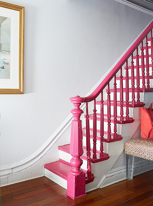 Fawn used a bit of “smoke and mirrors” to disguise a battered banister. Instead of a lengthy refinishing job, she painted it Benjamin Moore’s Gypsy Pink. “I wanted to distract from a certain unrefinement,” says Fawn.
