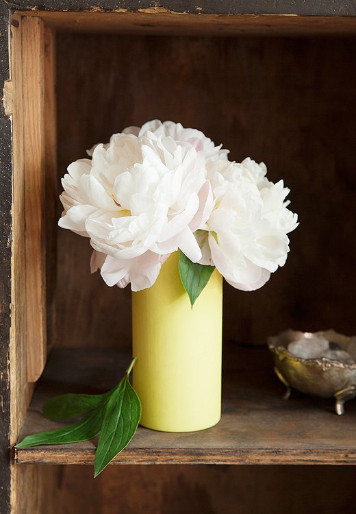 For next to the bed, think simple and sweet. Porcaro tucked a trio of peony blooms, and nothing else, into a low yellow vase for a result that’s calming, fragrant, and just plain lovely—perfect to wake up to.
