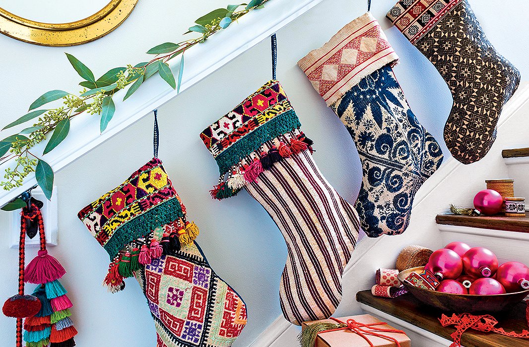 Why stop at the mantel? Hang stockings (exquisitely designed ones, of course) along your entry stairs too—pure fun.
