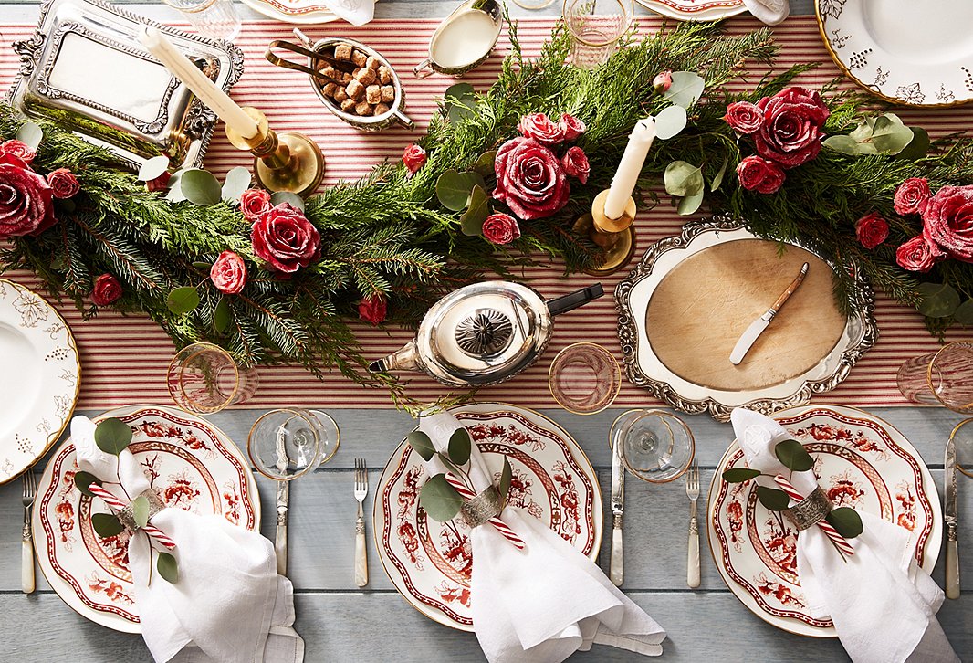 Classic holiday plates, timeless silver serveware, a stunning centerpiece of greenery and florals: This holiday look will always be in style. 
