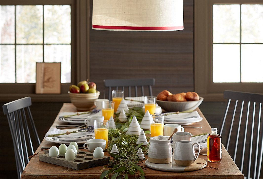 Farmhouse Pottery’s wares are a simple yet stunning way to set the table for any season. Use a garland of fresh greenery as the centerpiece to bring home the holiday look.
