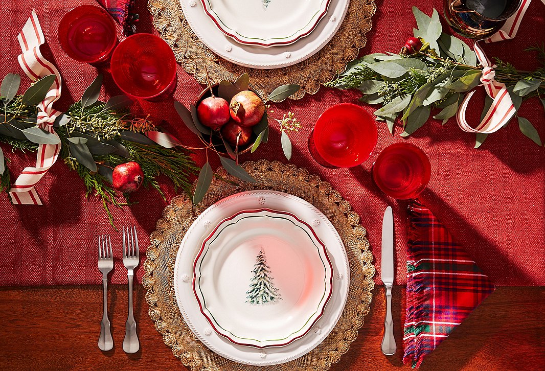 Mix and match everyday dinnerware (such as Juliska’s Berry & Thread Dinner Plate shown here) with holiday designs (such as the plate from Gien’s Noel collection and Juliska’s Christmas Tartan Dinner Napkin, also shown here) for an elegant and balanced seasonal look.
