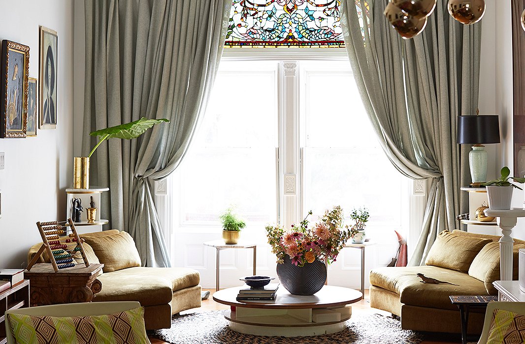 To frame the opalescent stained-glass window, Jodie put up dramatic curtains that pool generously on the floor.
