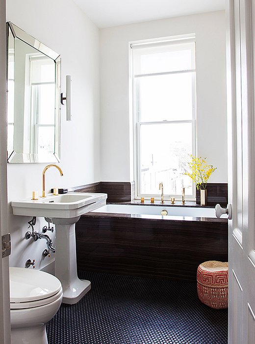 Julia loves taking baths—and who wouldn’t in this slick, one-of-a-kind space that overlooks the backyard? The woven wastepaper basket hails from Mexico.
