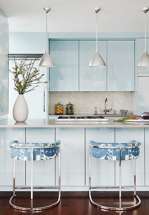 Soft colors can still be impactful. Lilse accentuated the blue in this kitchen by pairing it with a poppy ikat fabric. Design by Lilse McKenna; photo by Read McKendree.
