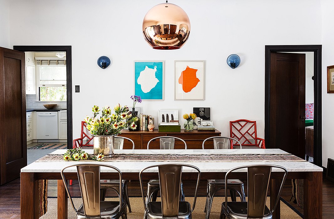 Lizzie designed the dining room around a copper Tom Dixon pendant. Embracing a casual vibe, she picked Tolix chairs and a natural-fiber rug to round out the room.
