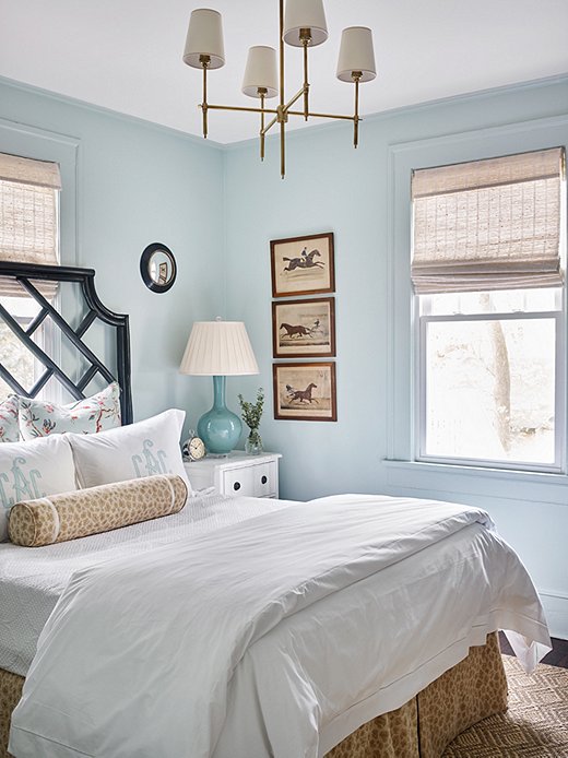 Benjamin Moore’s Palladian Blue sets the serene stage for the main bedroom. Natural tones play on the sunlit room to bring warmth. The Visual Comfort chandelier adds a touch of glam.
