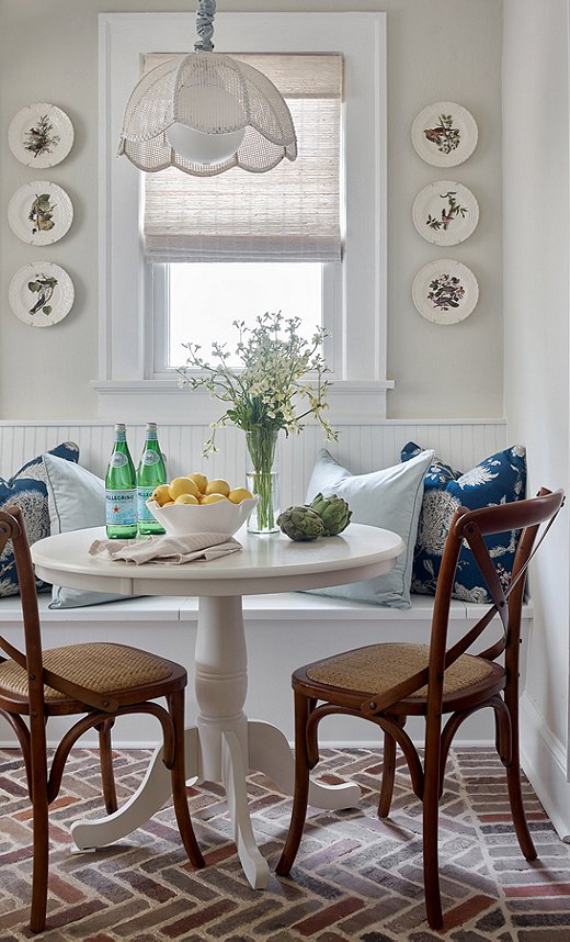 Brick flooring was a natural choice for this pet-loving family. The durable surface also adds a layer of informality and ease. Find similar side chairs here. 
