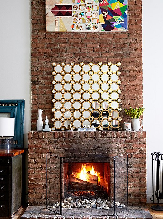 “We love sitting by the fire, especially in the winter,” says Lisa. On the mantel is an Art Deco-inspired mirrored piece Lisa bought years ago from One Kings Lane.
