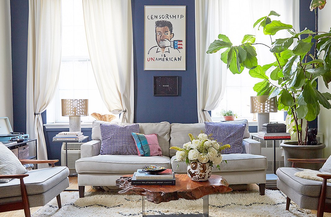 The painting hanging above the sofa in the living room is a prized find: The couple happened upon someone on the street who was throwing it out. “We took it home, and it’s the centerpiece of our apartment,” says Lisa.
