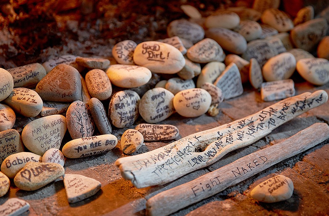 Tumbling out of the fireplace are rocks and driftwood from Lisa and Marlon’s wedding. Lisa’s mother collected them for the nuptials, and guests were invited to write messages and well wishes to the couple.
