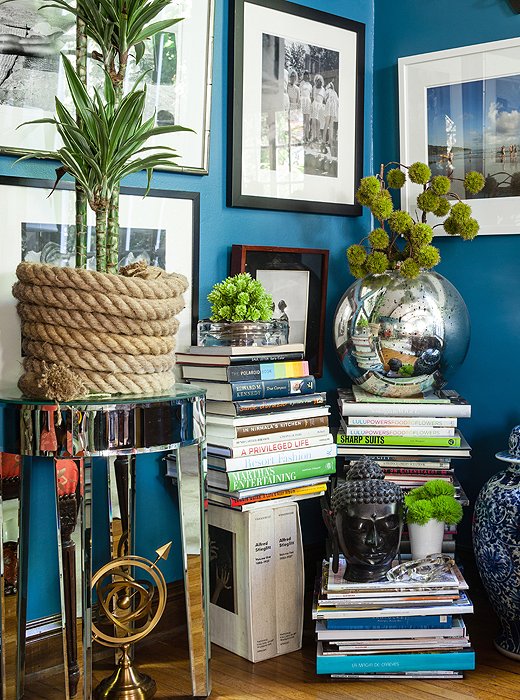 Filling an unused corner of the living room with stacks of books creates an eye-catching display that’s easy to move when it comes time to mix up the furniture arrangement.
