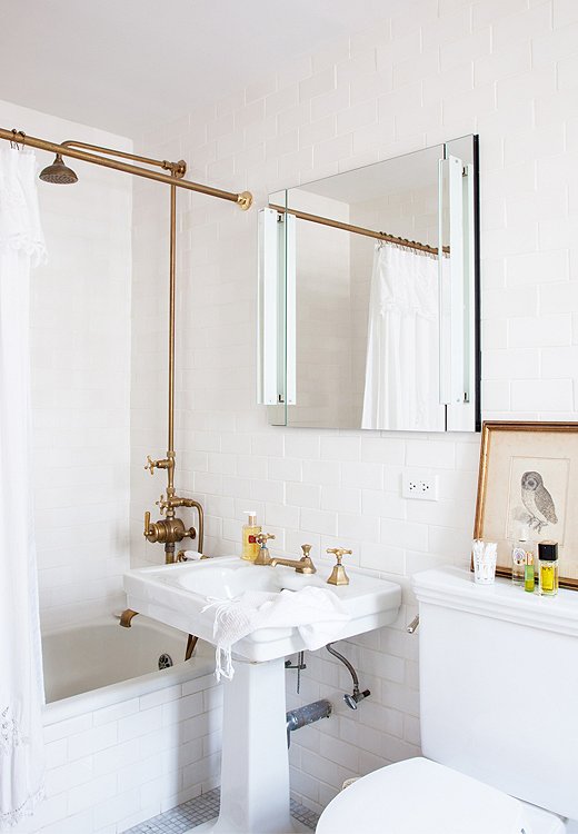 Designer Michelle Smith added unlacquered brass fixtures to her apartment’s pint-size bath, leaving everything else simple and unadorned. Photo by Lesley Unruh.

