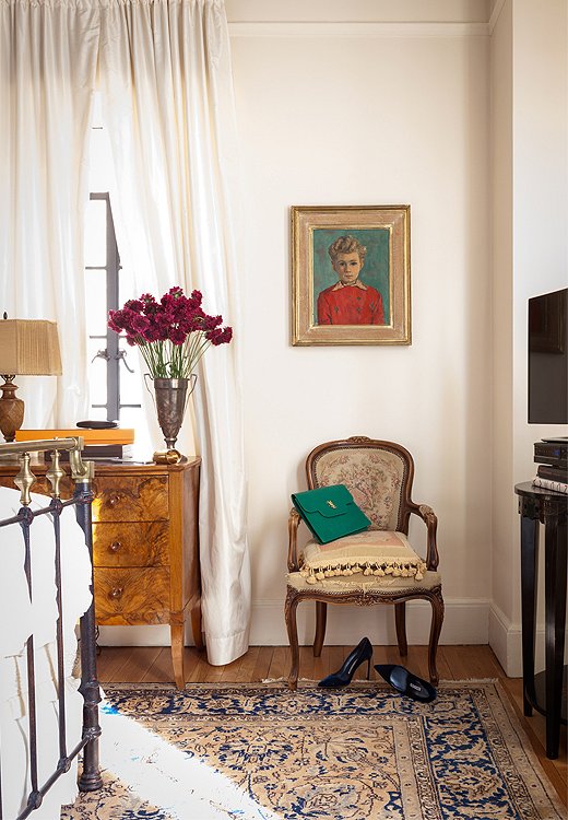 There’s only one pop of red in the whole apartment, and it’s this flea market painting of a little boy in a red shirt. Smith couldn’t resist, because the dimple on his chin matches hers and her grandfather’s.
