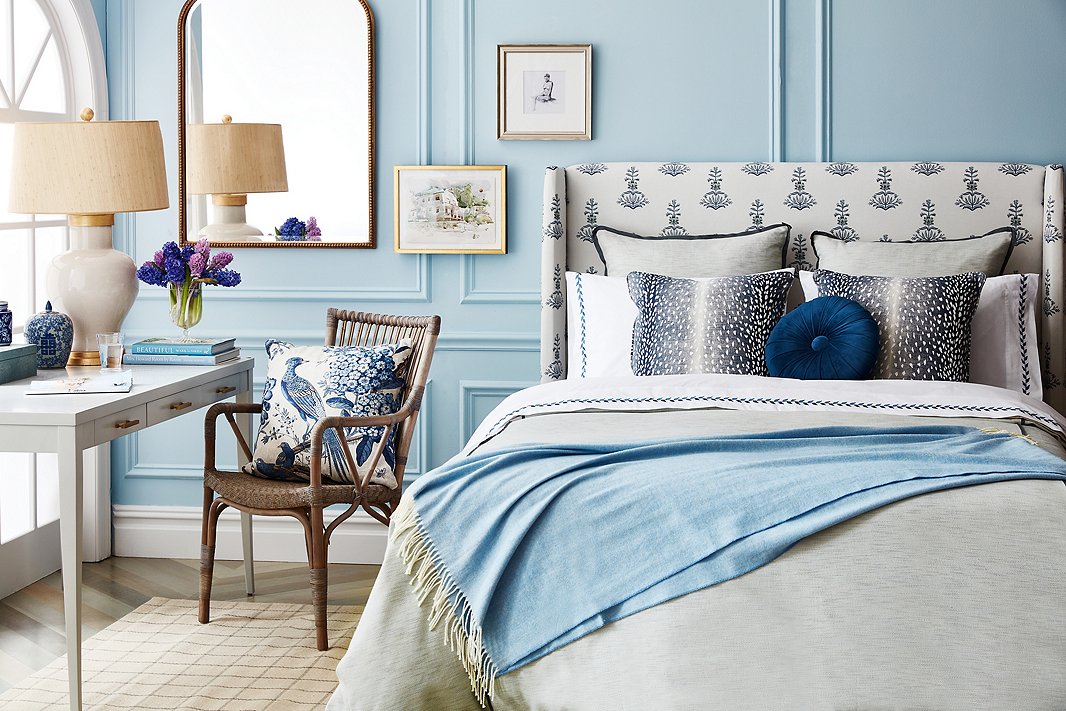 The variety of the blue hues ensures that the tight palette doesn’t feel flat. Furnishings above include Cleo Seagrass Table Lamp in Cream/Gold, Piano Armchair in Taupe Gray, Floral Pheasant Pillow in Beige (on chair), and Deerfield Rug.
