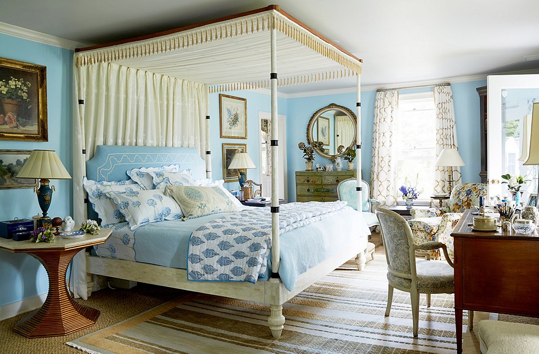 “It’s heaven” waking up in her pale turquoise bedroom, says Bunny. The bed, made of bone, was designed by John and built in his shop; the limestone-topped bedside table is from Bunny Williams Home.

