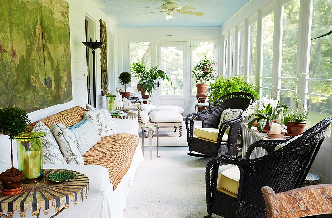 The porch—which features screen windows in the summer and glass ones in the winter—runs the length of the house. Bunny used a natural-tone palette so that “when you are in this room you feel like you are already in the garden.”
