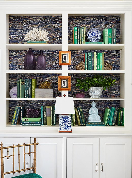 For a fun twist, try hanging framed artwork on the exterior of a bookshelf, as Jenn does here with these silhouette cameos.
