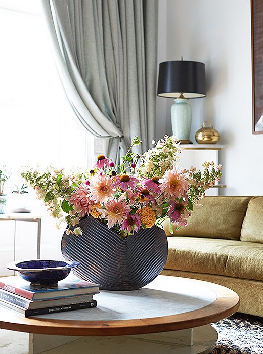 Jodie’s had this heavy ceramic vase forever. Here, it’s balanced by an airy, overspilling arrangement.
