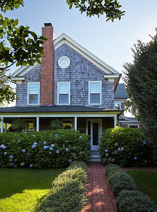 The circa-1885 Victorian farmhouse in the Hamptons town of Water Mill boasts a gracious mahogany porch characteristic of the era in which it was built.
