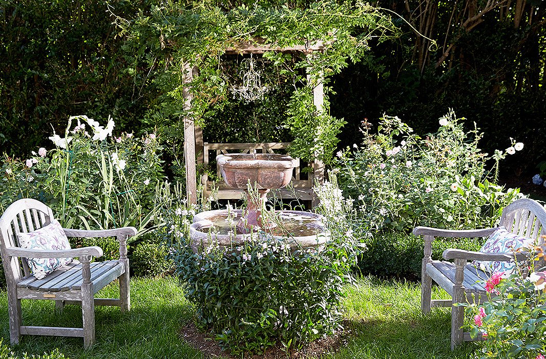 One corner of the grounds evokes the romanticism of a secret garden, from the antique limestone fountain shrouded with greenery to the trellis covered in a wild spray of climbing vines.
