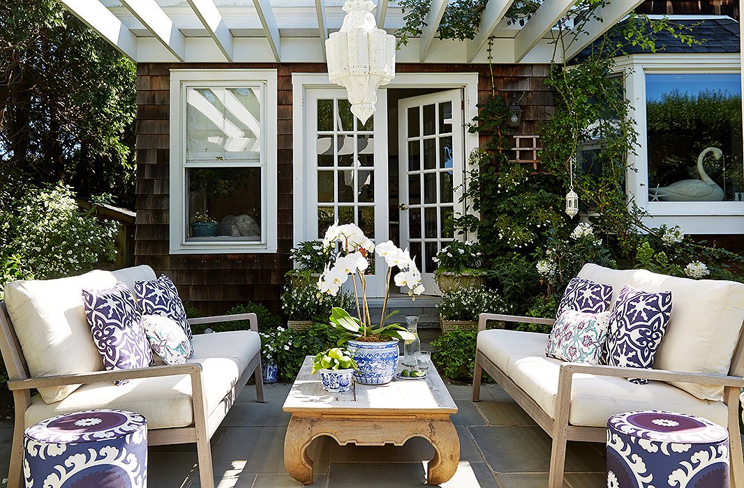 In summer Delaney and Kot spend as much time outdoors as they do inside the house. When she moved in, Delaney added an “entertaining space” off the kitchen with a large bluestone patio and cedar pergola, which she decorated with Eastern-inspired flair, adding Moroccan-style hanging lanterns and suzani-print poufs.
