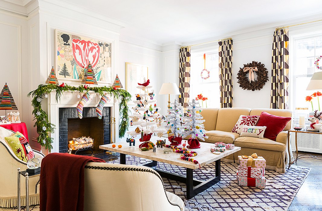 So many holiday elements are present, though even with the window wreaths, the mini twig trees, and the Christmas pillows, the room feels sophisticated, not kitschy.
