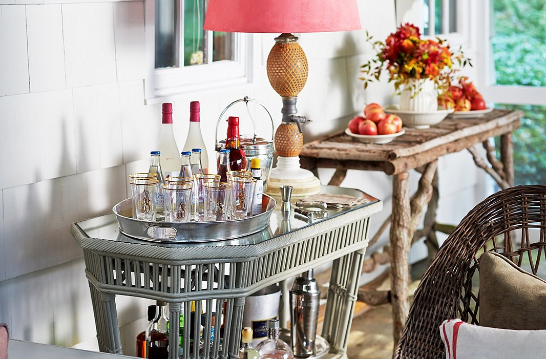A two-tier side table acts as a mini bar station. Sam uses a deep silver tray to keep glasses and drinks contained; it also makes serving guests a breeze.
