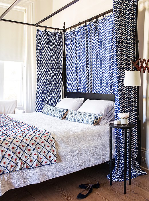 While eldest son Harrison was off at boarding school, Sara turned his room into a guest room. Roller Rabbit fabric that had previously served as kitchen curtains in New York now hang from the canopy. The colorful throw was found in a thrift store.
