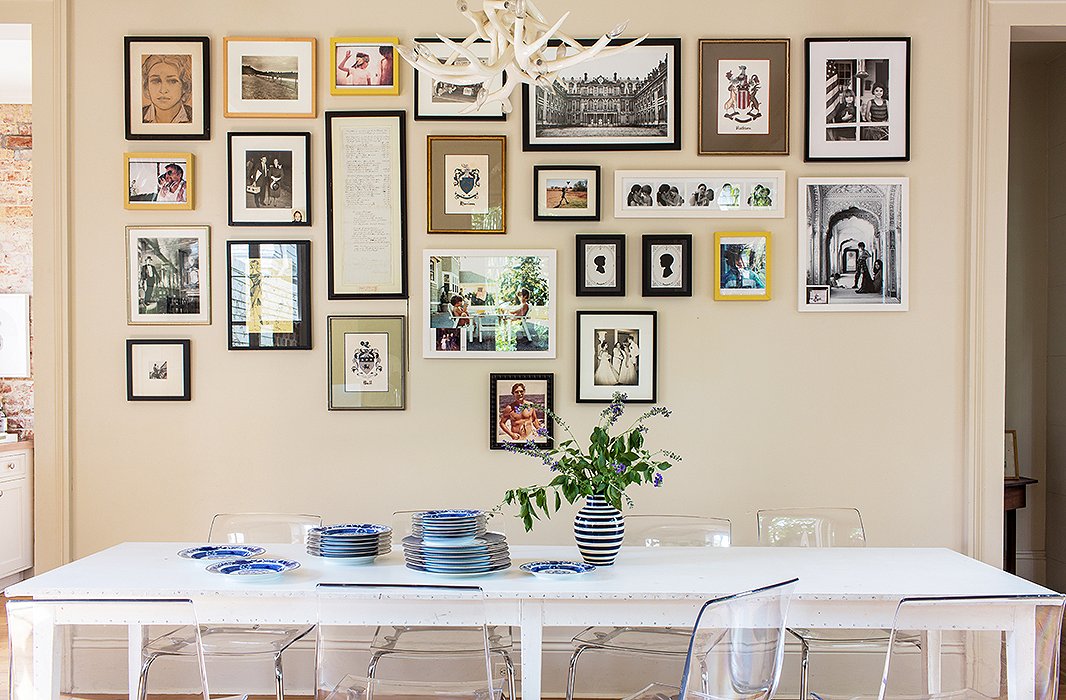 A neat grid of family photos (still in progress) hangs over the kitchen table, a “vintage ’90s” piece by fashion designer Ann Demeulemeester where the family eats all its meals. The plates are by Mottahedeh.
