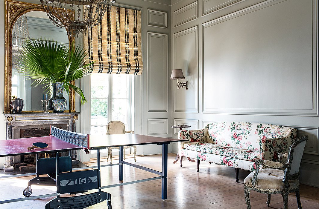 A ping-pong table turns an unused formal dining room into the ultimate hangout space. Chintz and gold complete the high-low mix. Photo by Nicole LaMotte.
