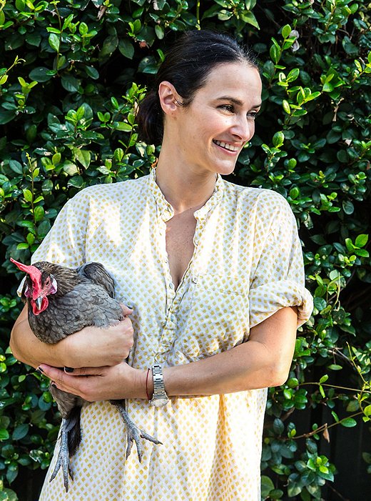 Sara with one of the family’s nine chickens, which lay the eggs the family eats and Carolina delights in selling door-to-door. “Chickens are easy if you have a coop. If you do free-range that’s a whole other story. But these are very easy.”
