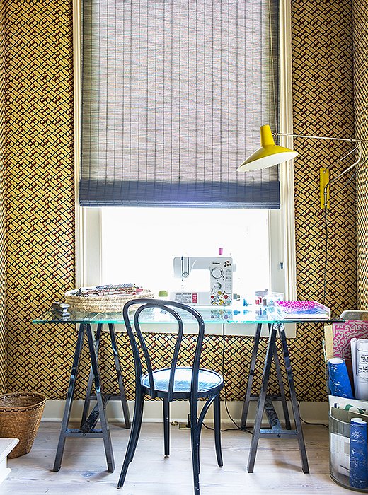 Just as the trellis room downstairs is visible from the front door, Kiki’s sewing room, directly above it, is visible from the top of the stairs. “I like to max out these focal-point rooms.” Sara turned this small space into a statement by covering the walls in Muriel Brandolini fabric.
