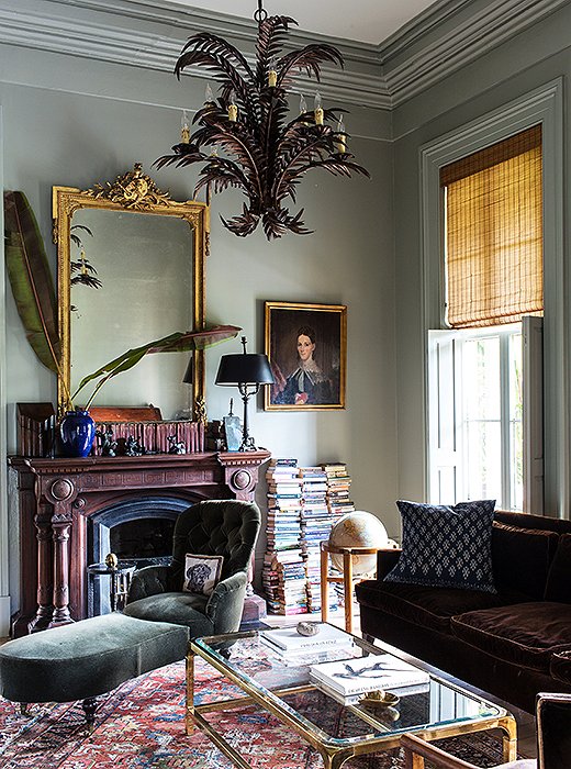 The library is made cozy by the layers of worn rugs and velvet upholstery, and memorable by the addition of an over-the-top lamp (formerly covered in Mardi Gras beads) that Sara found at a secondhand store.
