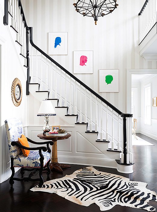 Silhouettes of the couple’s children—in neon colors rather than the traditional black-on-white—line the staircase.
