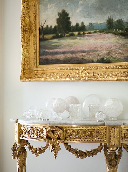 While most of her furniture leans more tailored, Suzanne mixed in a few ornate elements for contrast. Case in point: this gilded console, which houses her collection of rock-crystal spheres.
