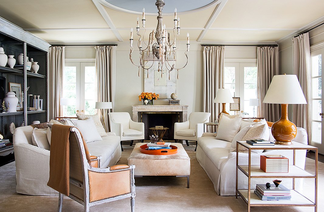 Suzanne added these geometric moldings to the family room ceiling, giving the space more of a presence. Painted ice blue, the center circle sets off the room’s orange accents.
