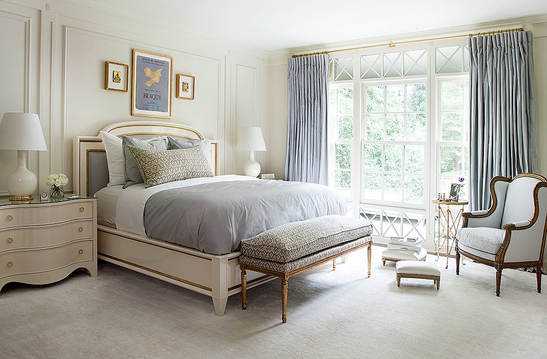 Touches of gold are woven throughout Suzanne’s bedroom, from the detail on the bed to the base of the table lamp to the ornate frame of the upholstered bench.
