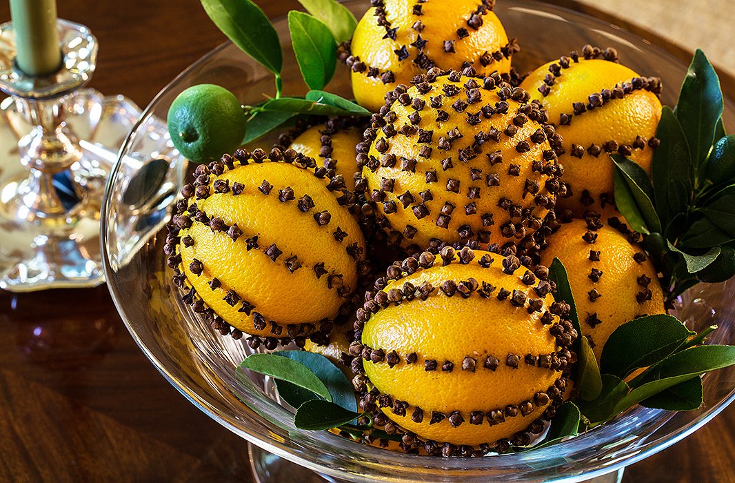 Classic pomanders, oranges studded with dried cloves, make a chic statement piled high in a crystal bowl.
