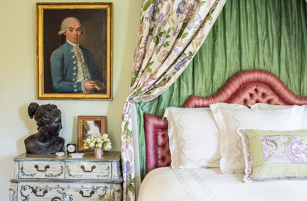 In Kathleen’s room everything is very muted except for the bed, which features a pink satin headboard and drapes made of Timothy’s lavender-and-green floral lined in silk. “I wanted to create a wonderful feminine room using lavenders and greens and pinks.”
