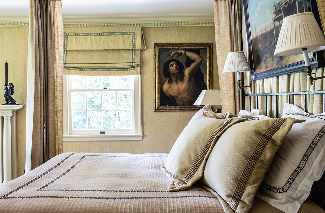 In the master bedroom, Timothy used a similar fabric to upholster the walls and make the shades and the bed drapes. “Upholstering a bedroom cuts sound and creates a very cozy, intimate feeling.”
