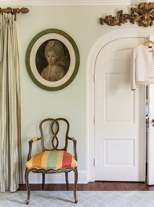 An oversize stripe modernizes an 18th-century chair and really stands out in the otherwise pale bedroom. “I like to go with quieter palettes and then let punches of color come in through a pillow, a painting, or an object, but not be overwhelming.”
