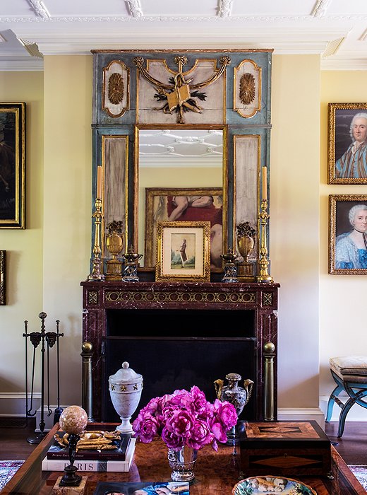 The walls are oatmeal-colored and the upholstery mostly neutral so as not to detract from the objects, including a striking red marble fireplace found in France.
