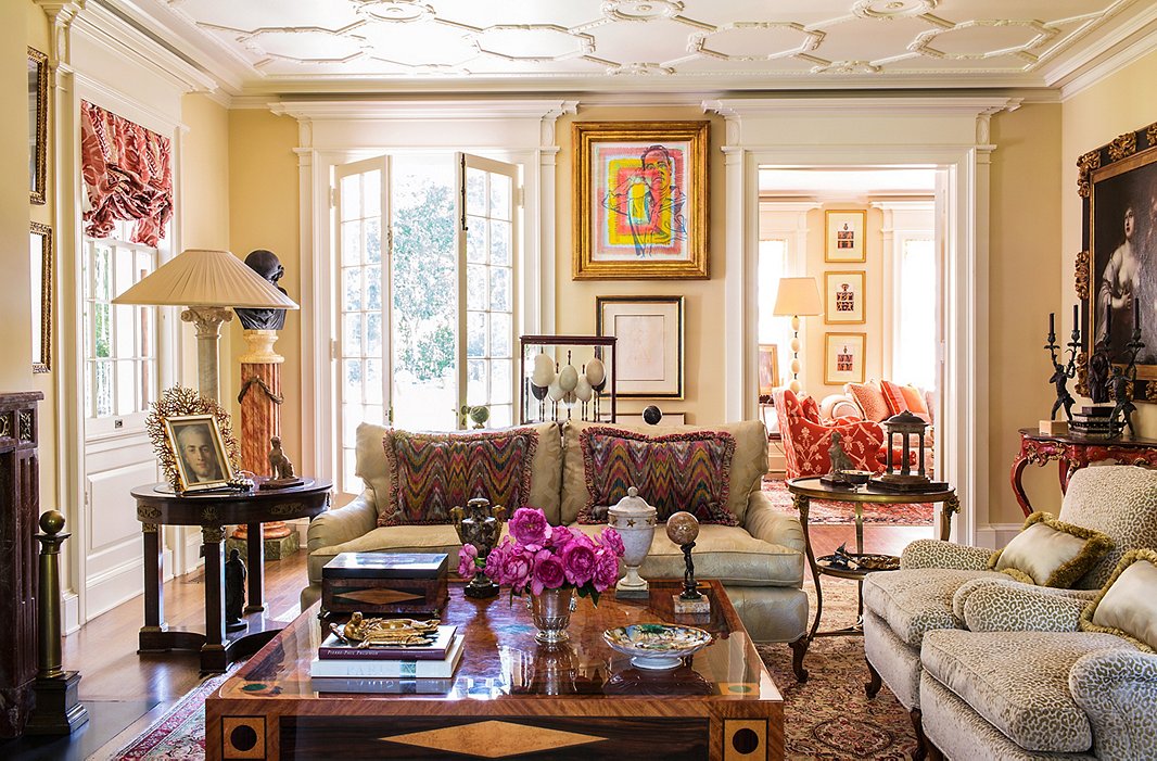 Timothy’s richly layered living room combines the modern (including a Timothy Corrigan Home coffee table and a colorful portrait of Timothy by Don Bachardy) with antiques including a red 18th-century Venetian table.
