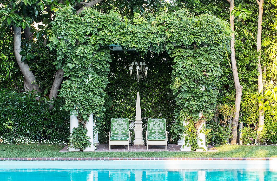 Timothy doesn’t swim many laps these days—and has an explanation few interior designers can match: “I burned out.” As a youth, he swam six or seven hours a day and made it to the Olympic trials at age 18 (sadly, he didn’t make the team). The pergola covered with wisteria and a chandelier create an “outdoor living room.”
