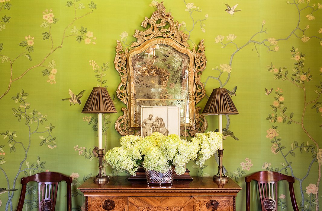 The walls of the library/dining room are hand-painted silk, and the chest and the mirror are high-end antiques, but the lamps are not. “You don’t have to spend a lot of money on lamps if you have good lampshades. I paid about $100 for these and then spent the money on the shades.”
